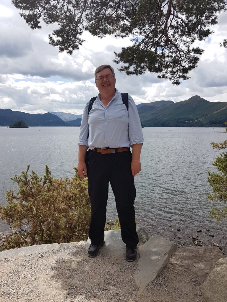 keith Rose standing by a lake